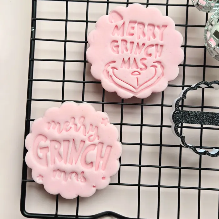 20250918_131738 Close-up of Grumpy Christmas funny festive cookie stamp and fondant embosser impression on fondant