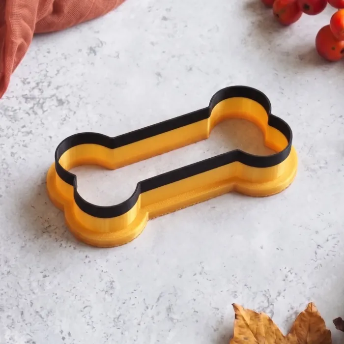Halloween bone cookie cutter with bone-shaped fondant decoration (1) Halloween Bone Cookie Cutter | Skeleton Fondant & Biscuit Cutter