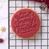 HAve Have Yourself a Merry Little Christmas cookie stamp shown on a finished festive biscuit