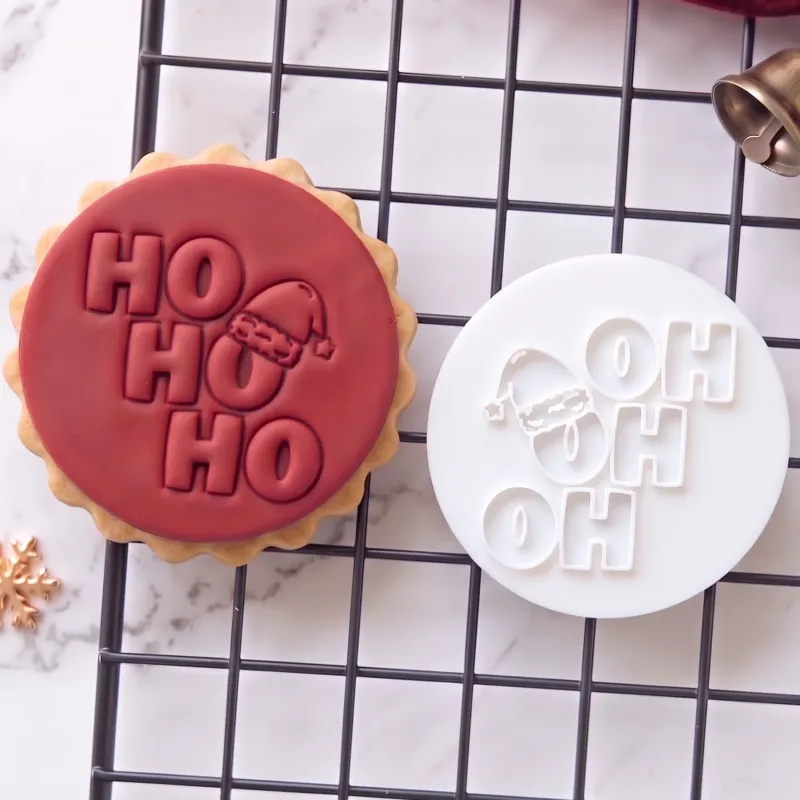 HO HO HO Christmas Cookie Stamp (1) Ho Ho Ho Christmas cookie stamp with Santa hat shown on a finished festive biscuit