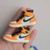 custom basketball jersey cake topper with name and number 23 and two orange high top sneaker cake toppers