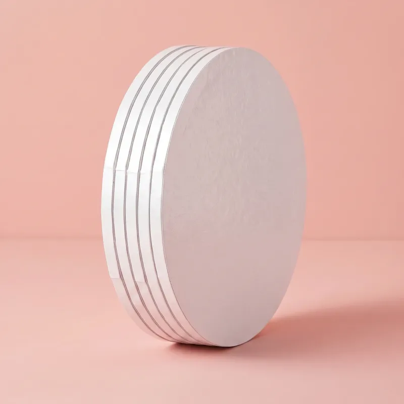 Side view of a white 12 inch round cake board showing its raised edge
