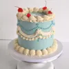20260904_091900 Decorated 8 inch celebration cake displayed on a white 10 inch round cake board