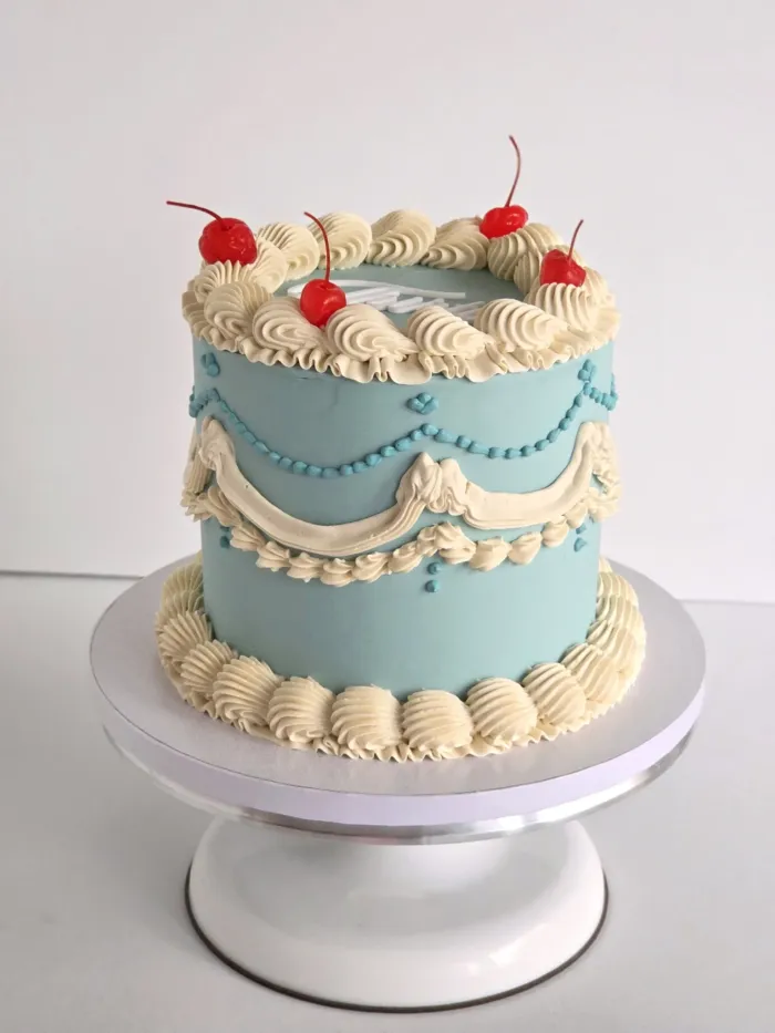 20260904_091900 Decorated 8 inch celebration cake displayed on a white 10 inch round cake board